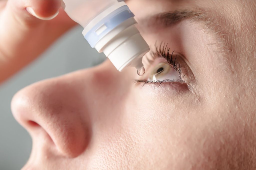 woman-usingd-eye-drops-dr-qaisar-ahmed-dixe-cosmetics